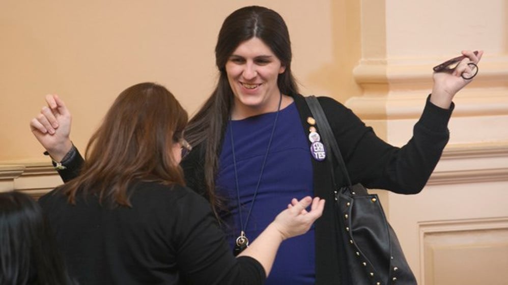 Virginia Del. Danica Roem, D-Prince William, right, hugs Del. Debra Rodman, D-Henrico, at the end of the 2018 session of the Virginia General Assembly session at the Capitol in Richmond, Va., March 10, 2018. (AP Photo/Steve Helber)