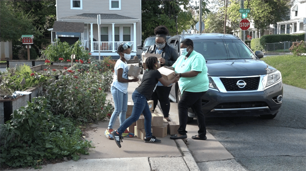 Students receiving climate action kits at home.